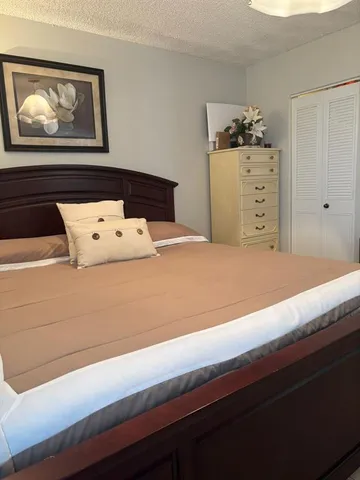 a bedroom with a bed and cabinets