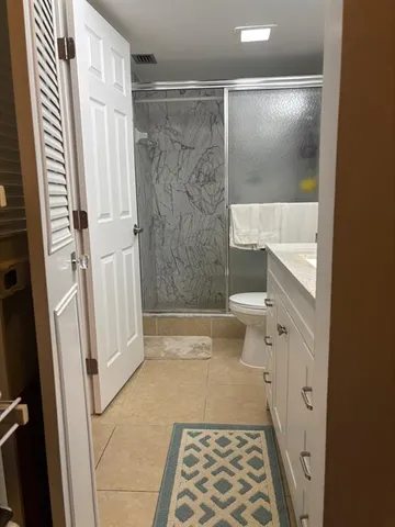a bathroom with a shower and a toilet