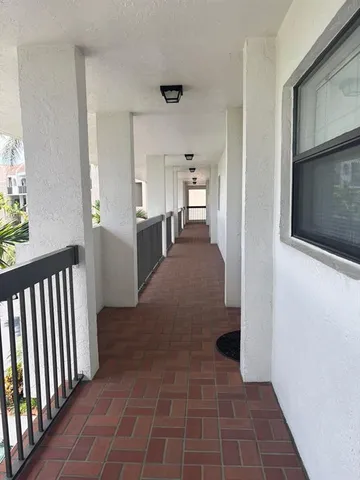 a view of a hallway with kitchen and entryway
