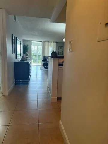 a lobby with a chair and frames on wall