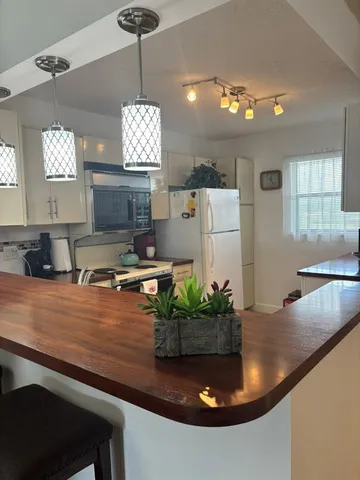 a dining table with chairs and window