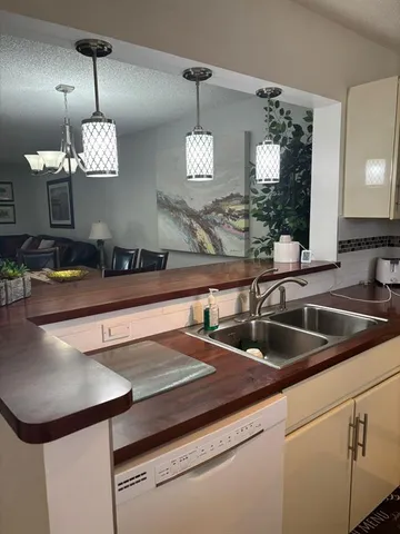 a kitchen with a sink and chandelier
