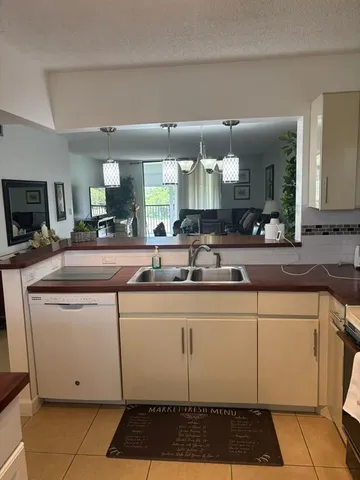 a kitchen with stainless steel appliances a sink stove and cabinets