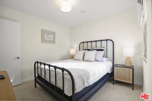 a large bed sitting in a bedroom next to a small yard