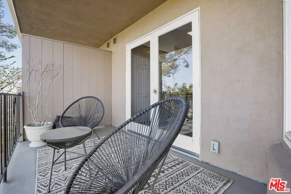 a view of a balcony with furniture