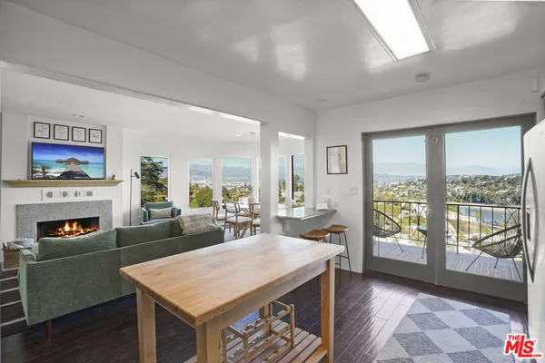 a view of a livingroom with furniture window and wooden floor