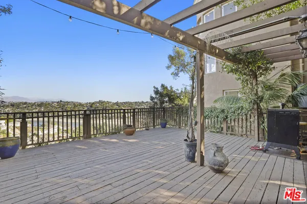 a view of a balcony with wooden floor