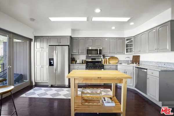 a open kitchen with sink cabinets and refrigerator