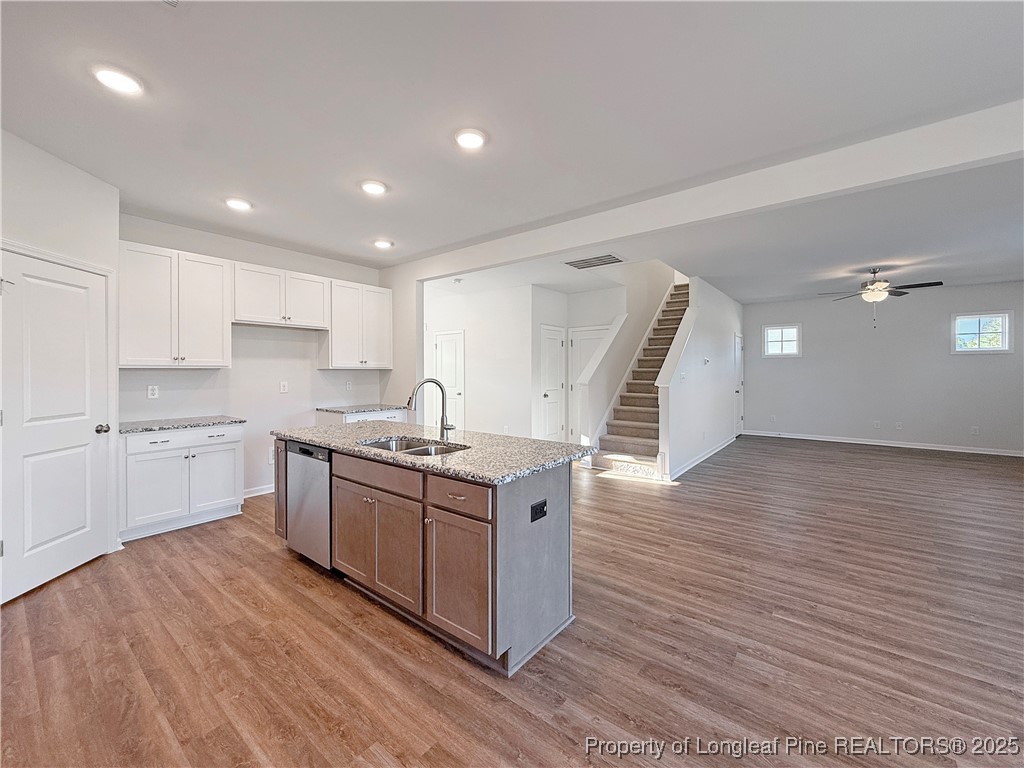 514 Ashley Heights Raeford, NC 28376 - Photo 13 of 39 a kitchen with stainless steel appliances granite countertop a sink cabinets and wooden floor