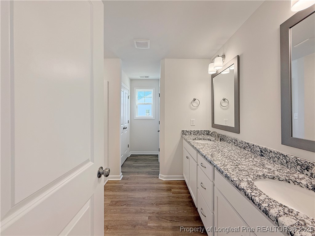 514 Ashley Heights Raeford, NC 28376 - Photo 25 of 39 a spacious bathroom with a granite countertop sink and a mirror