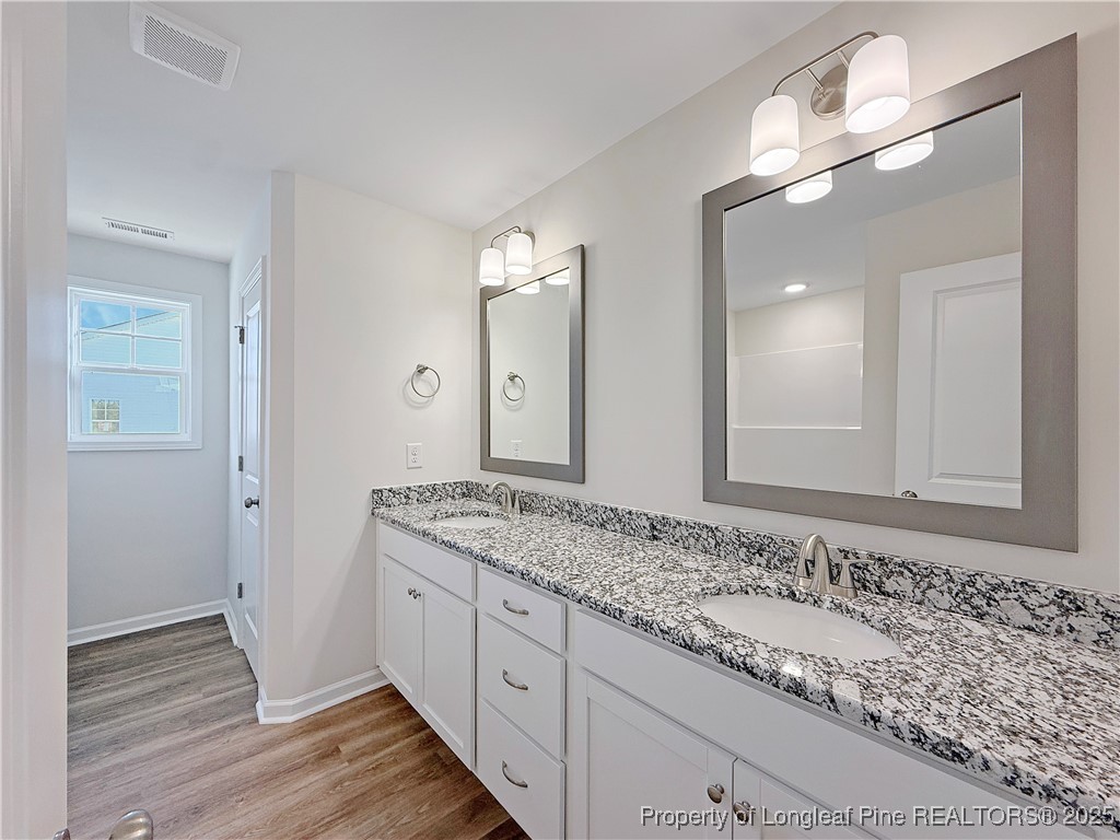 514 Ashley Heights Raeford, NC 28376 - Photo 26 of 39 a bathroom with a granite countertop sink and a mirror