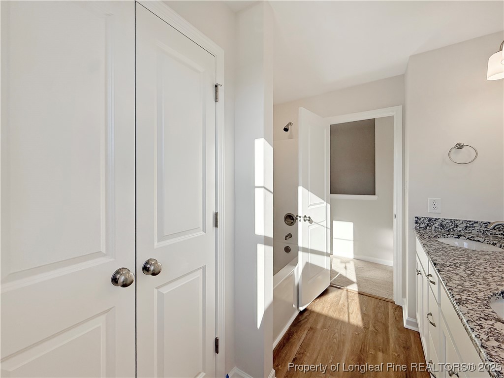 514 Ashley Heights Raeford, NC 28376 - Photo 37 of 39 a bathroom with a granite countertop sink a vanity and shower