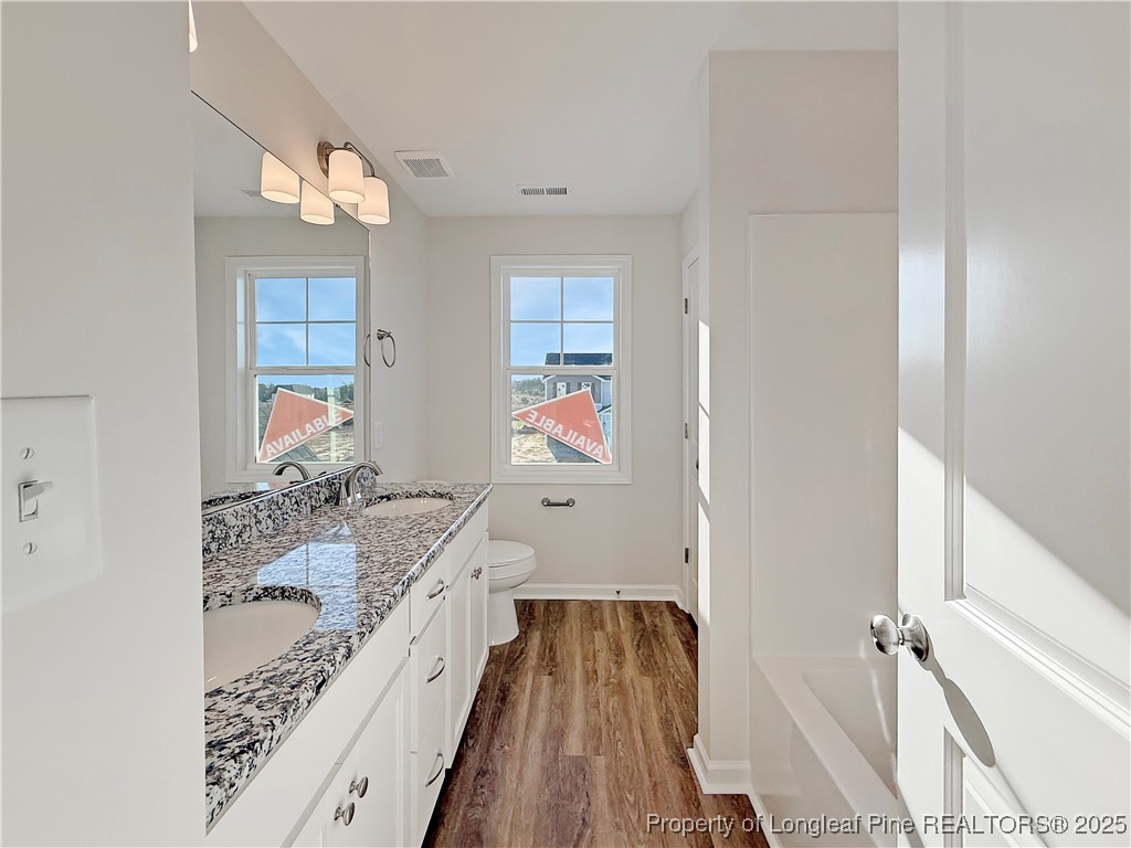 514 Ashley Heights Raeford, NC 28376 - Photo 38 of 39 a bathroom with a bathtub and a double vanity sink