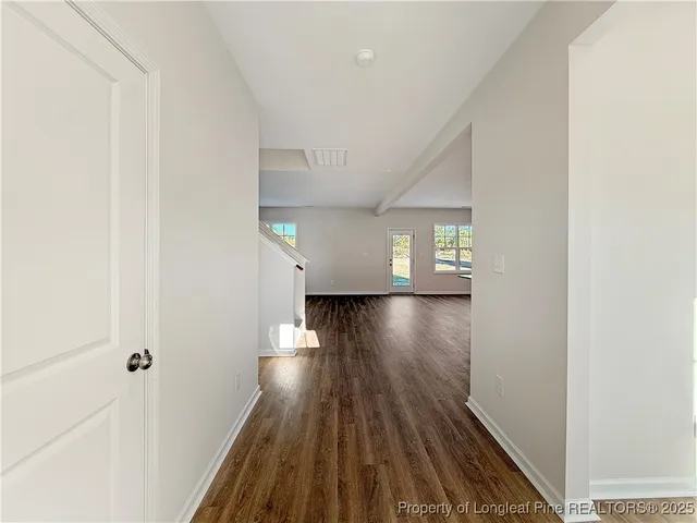 a view of a hallway with wooden floor