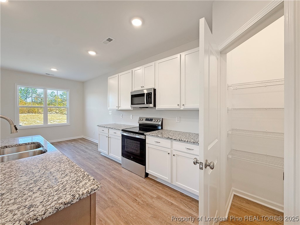 514 Ashley Heights Raeford, NC 28376 - Photo 9 of 39 a kitchen with granite countertop white cabinets and appliances