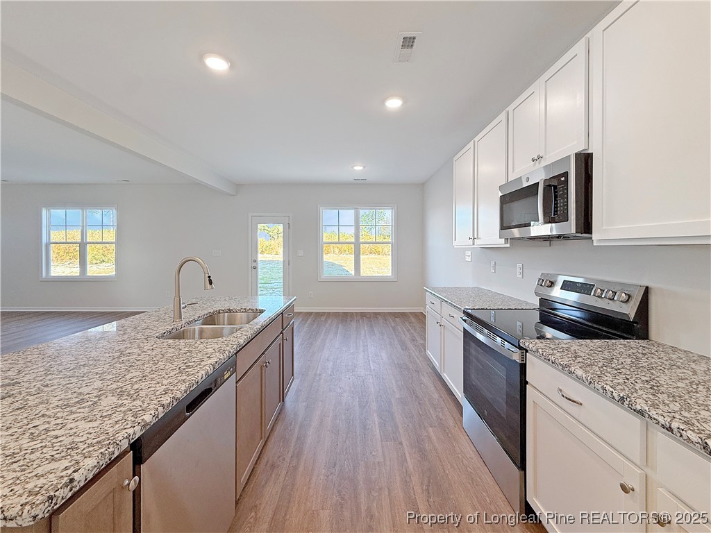 514 Ashley Heights Raeford, NC 28376 - Photo 10 of 39 a kitchen with granite countertop stainless steel appliances and wooden cabinets