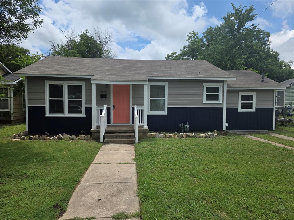 2804 Summer Avenue Waco, TX 76708 - Photo 3 of 13 Charming bungalow with multi-tone siding, a distinctive coral-hued entry door, a covered front porch with white railings, and a concrete walkway