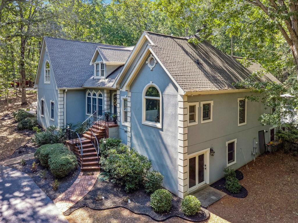 a view of a house with brick walls and a yard