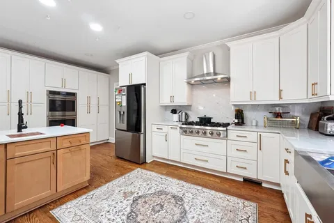 a kitchen with stainless steel appliances granite countertop a refrigerator sink and cabinets