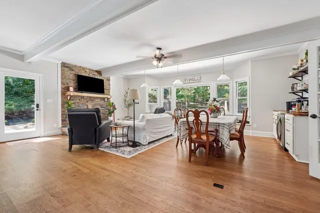 a view of a livingroom with furniture window and wooden floor