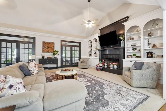 a living room with furniture a fireplace and a flat screen tv
