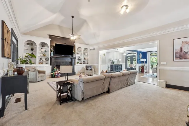 a living room with furniture a flat screen tv and a fireplace