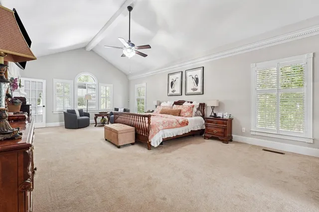 a bedroom with bed and a chandelier
