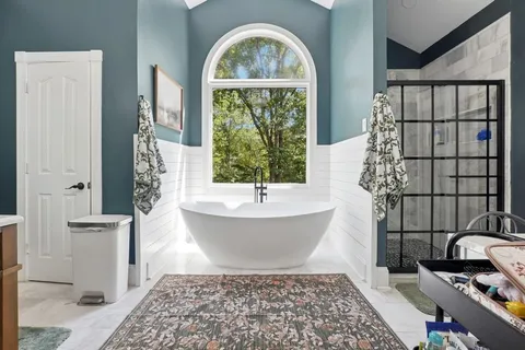 a bathroom with a bathtub and shower