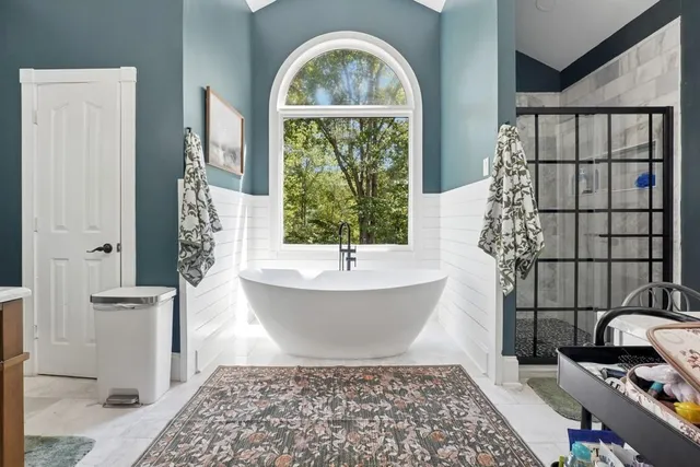 a bathroom with a bathtub and shower