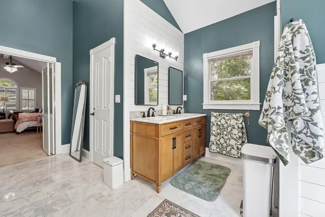 a bathroom with a double vanity sink mirror and