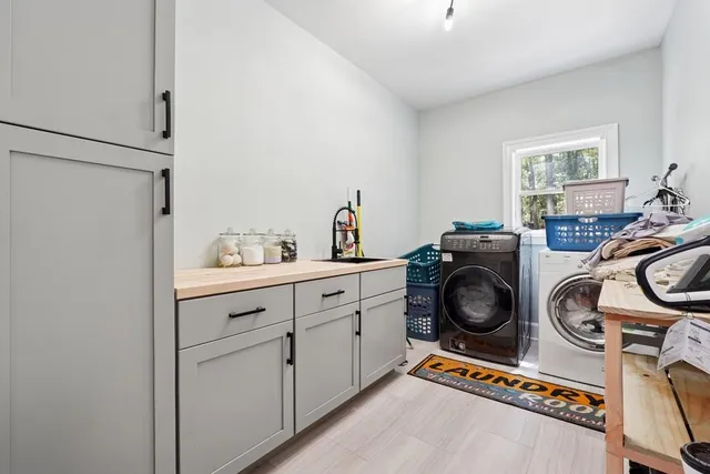 a utility room with sink dryer and washer