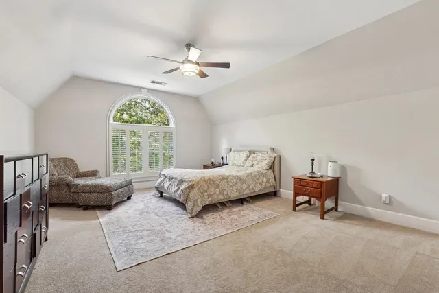 a bedroom with furniture and a large window