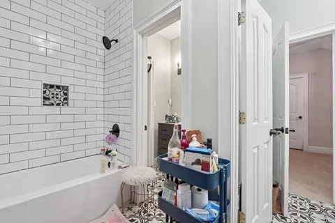 a bathroom with a bath tub a sink and a shower curtain