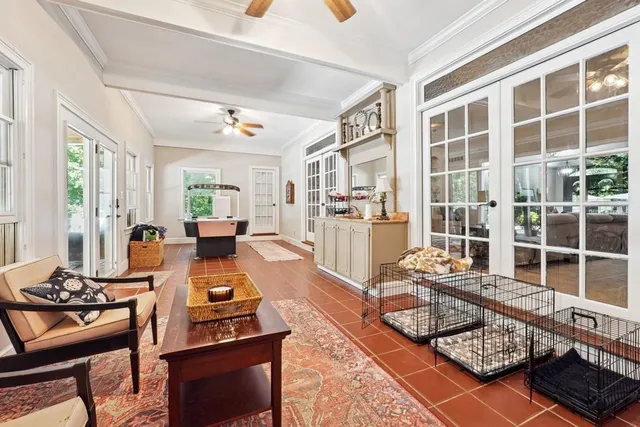 a living room with furniture a rug and a window