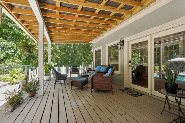 a balcony with furniture and wooden floor