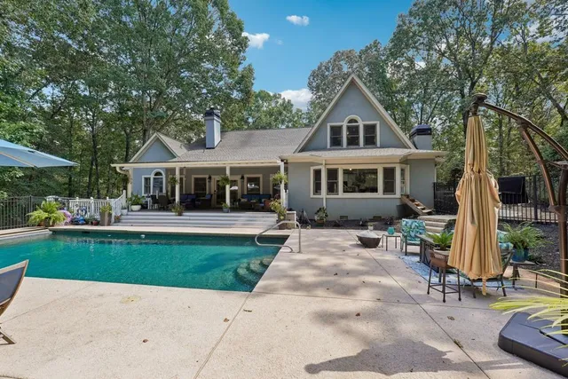 a front view of a house with a yard table and chairs