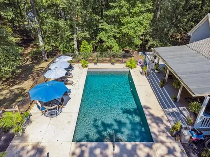 a view of a backyard with swimming pool
