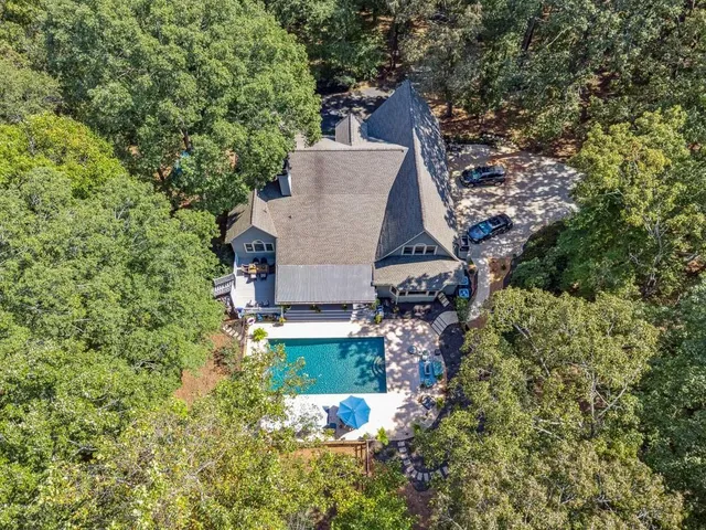an aerial view of a house with a yard basket ball court and outdoor seating