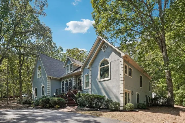 a front view of a house with a yard and potted plants