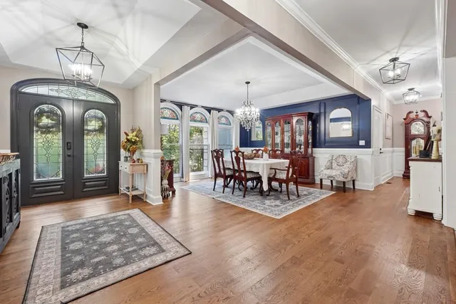 a living room with furniture and a chandelier