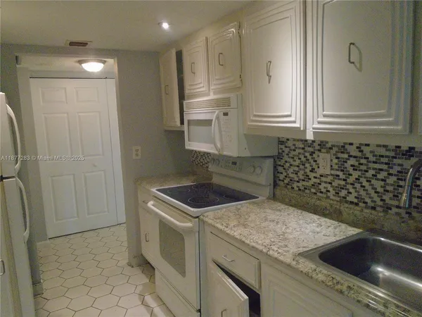 a bathroom with a shower and a sink