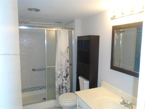 a bathroom with a toilet a sink and shower