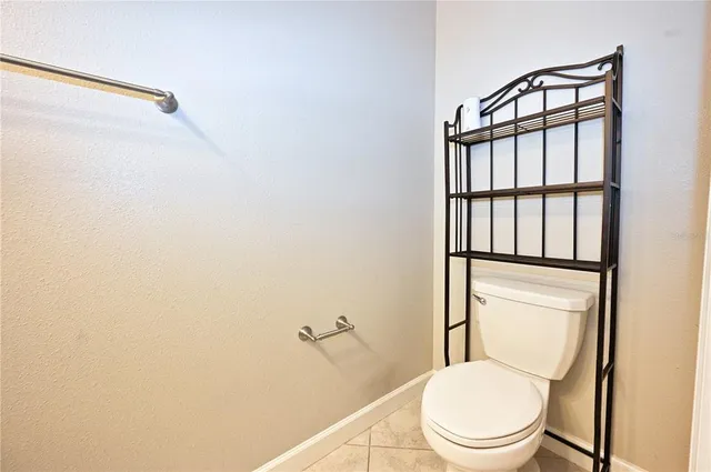 a white toilet sitting next to a bathroom sink
