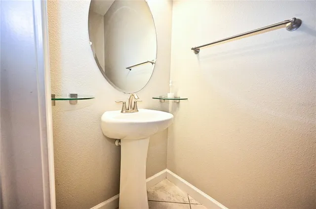 a bathroom with a sink and mirror