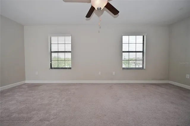 an empty room with windows and closet