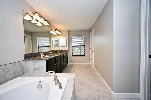 a large bathroom with a sink a vanity and a mirror