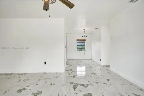 a view of a refrigerator in kitchen and an empty space in the view