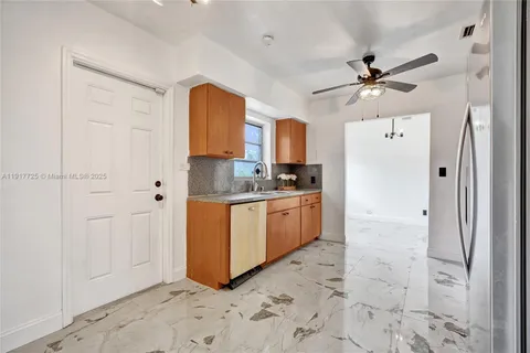 a kitchen with a refrigerator a sink and dishwasher