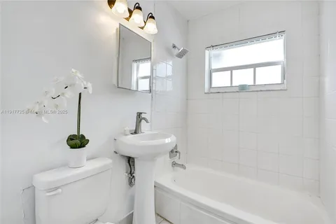 a white toilet sitting next to a bathroom sink