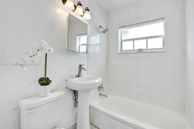 a white toilet sitting next to a bathroom sink